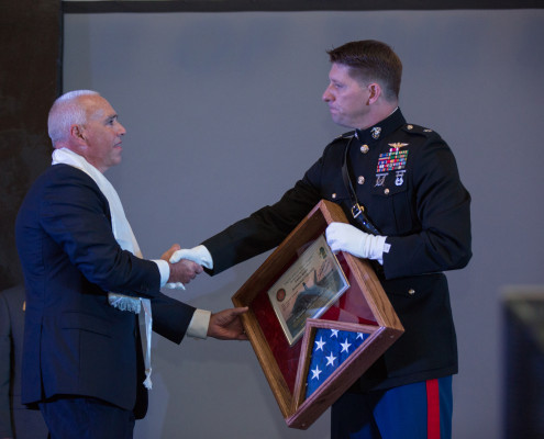 Executive Director of Alumni Relations Bill Thompson shakes hands with with USMC Retired Lt. Col. Chad Schwarm Alumni Recognition Awards Banquet in the Eagle Gym on Embry-Riddle Aeronautical University's Prescott Campus, in Prescott, AZ, October 2, 2015.