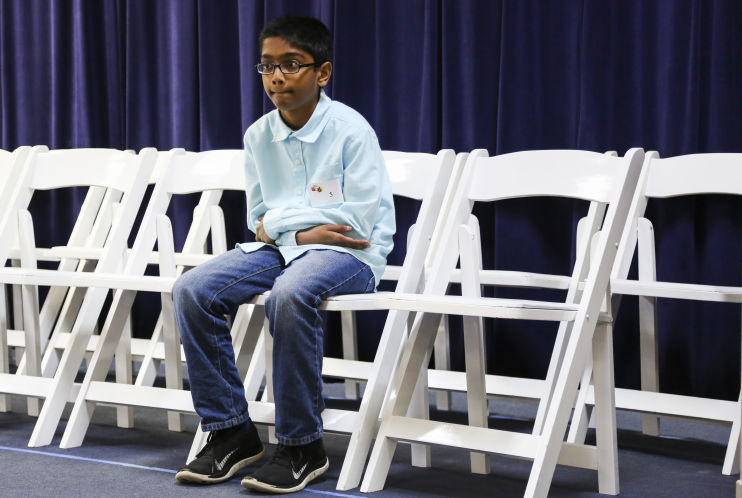 EVE EDELHEIT | Times | Ammaar Mohammed, 12, from Bayaan Academy waits to spell his word in the final round of the Tampa Bay Area Scripps Regional Spelling Bee at Admiral Farragut Academy in St. Petersburg on Saturday, March 12, 2016. Mohammed went on to win the bee with the word, valetudinarian. Mohammed will travel to Washington D.C. in May to compete in the Scripps National Spelling bee.