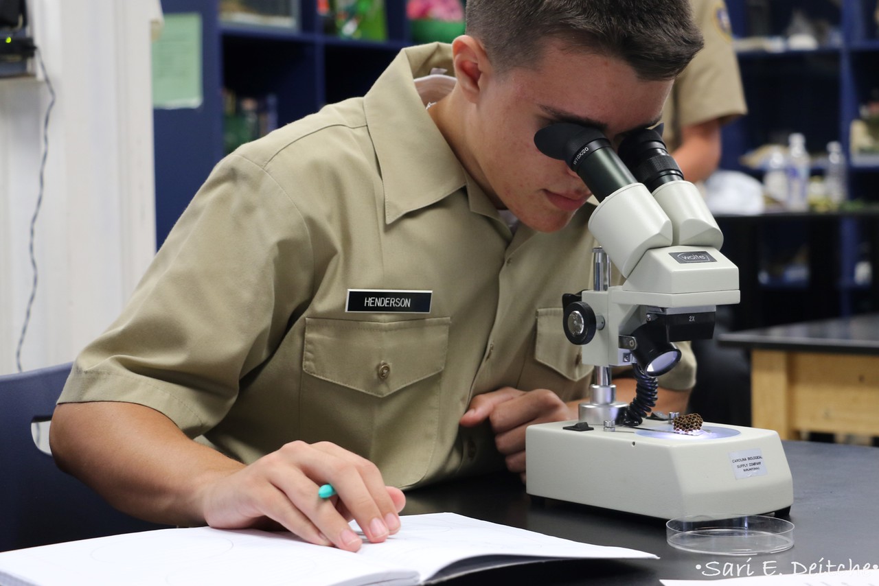 Biology student with microscope
