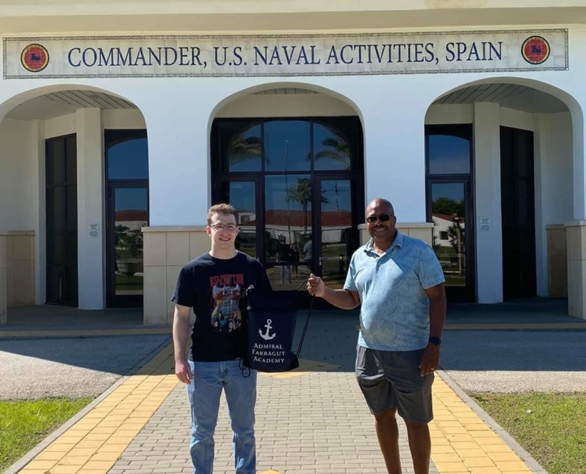 Farragut Alumni Ethan Lipsky ‘18 and Michael “Mike” Harris ‘76N stand in front of U.S. Navy Commander station in Spain.